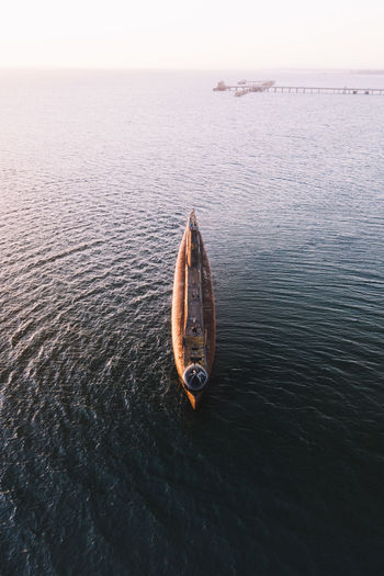 Aerial view of boat in sea against sky