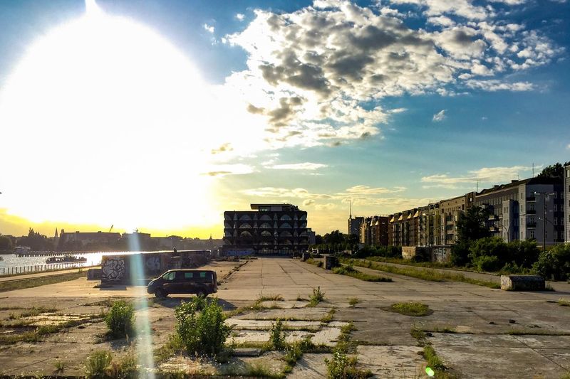 Road leading towards city during sunset