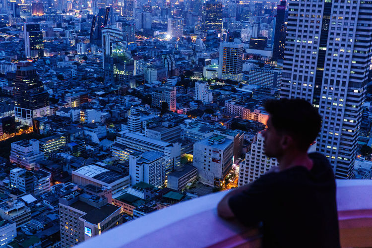 Man looking over a city at night