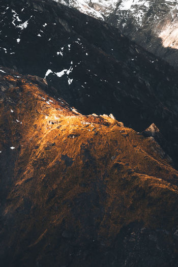 Patch of golden light on the top of a mountain.