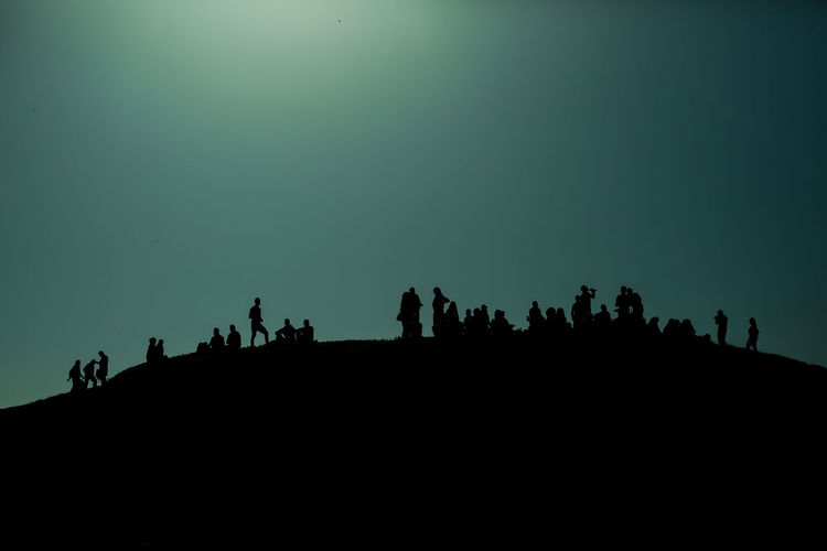 Silhouette of people against clear sky