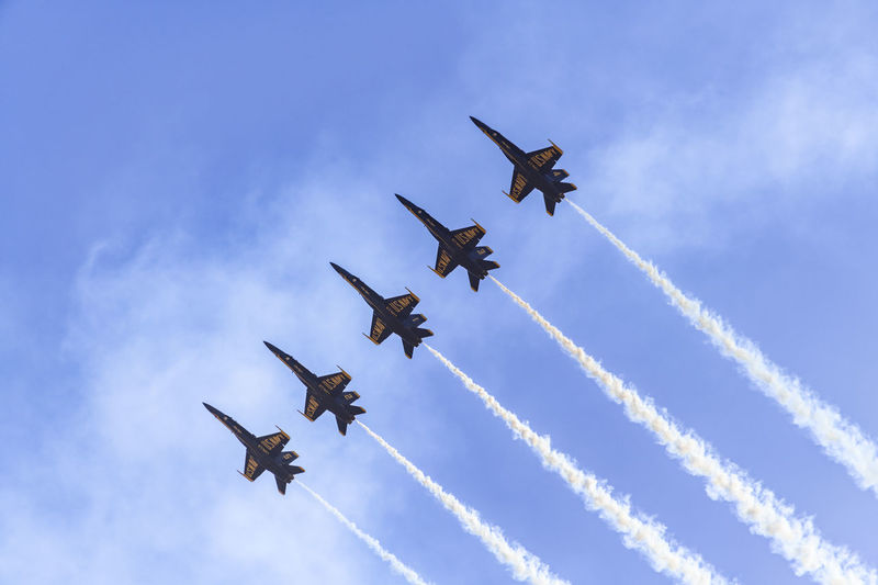 Low angle view of airshow against sky