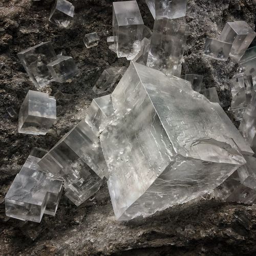 Close-up of ice crystals on rock against glass