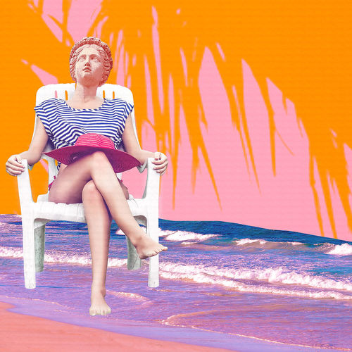 Full length of woman sitting on beach