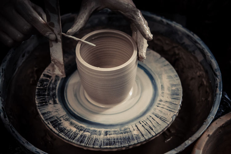 Creating ceramic products of white clay close-up. the sculptor in workshop makes clay jug closeup.