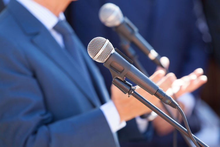 Midsection of businessman giving speech during event