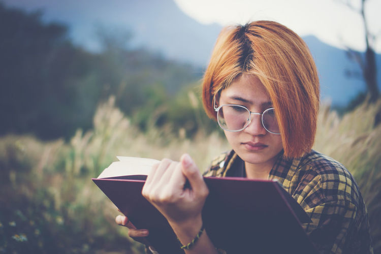 Portrait of woman holding smart phone outdoors