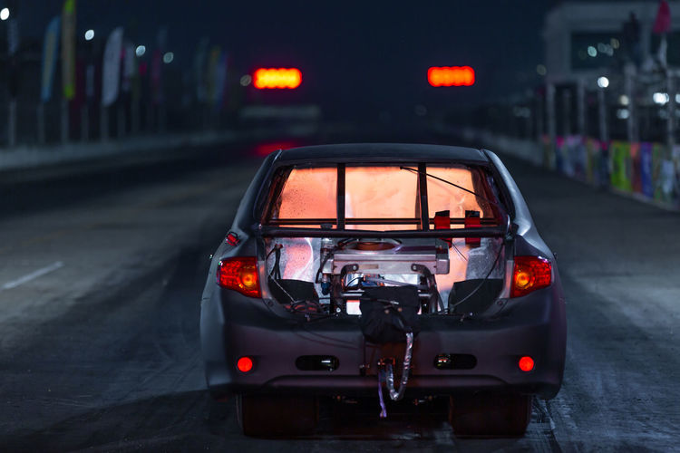 Drag racing car at the start competition at night, drag race car in race track at night.