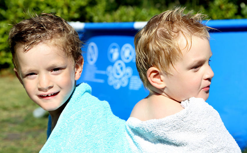 Portrait of of boys by swimming pool