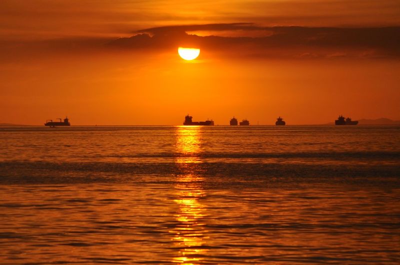 Scenic view of sea against orange sky