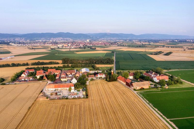 High angle view of agricultural field against buildings