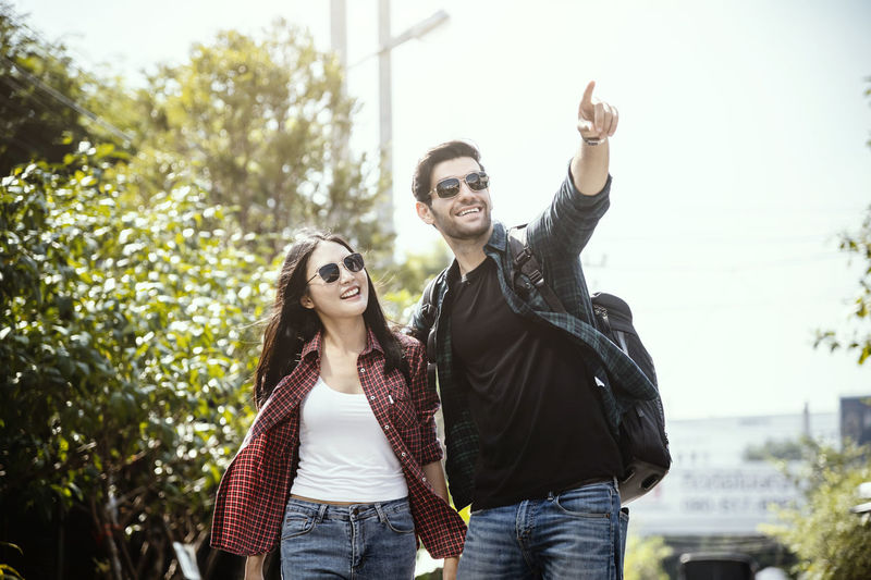 Portrait of smiling young couple standing outdoors