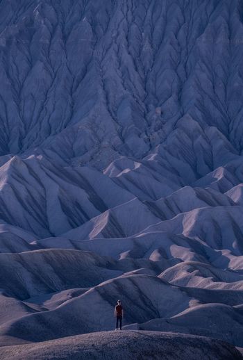 Rear view of man on snowcapped mountains