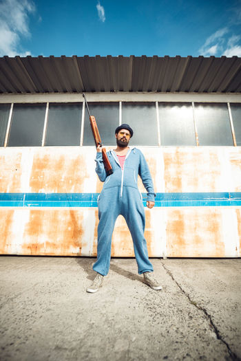 Full length of man standing against wall