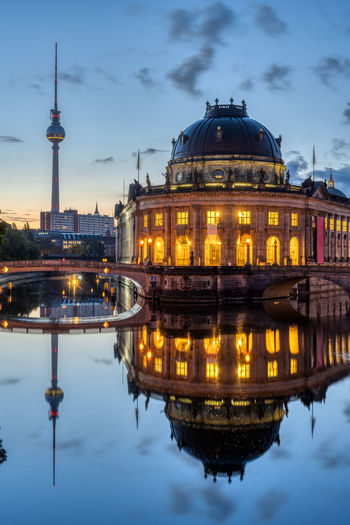 The bode museum and the television tower reflected in the river spree in berlin at dawn