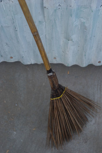 Broom by corrugated iron