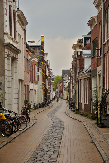 Bicycles on road by buildings in city