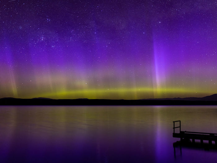 Scenic view of lake against sky at night aurora 