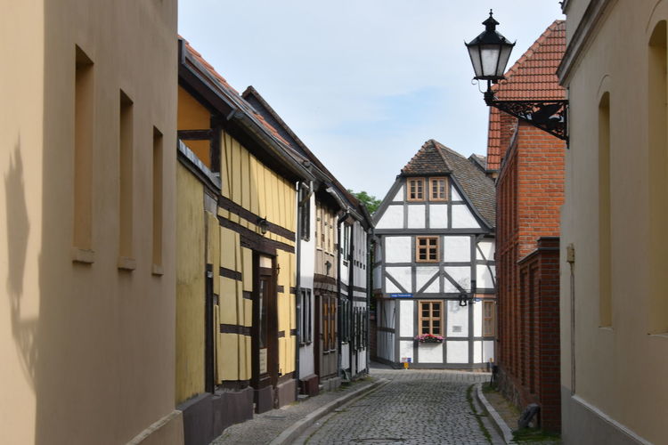 Street amidst buildings against sky