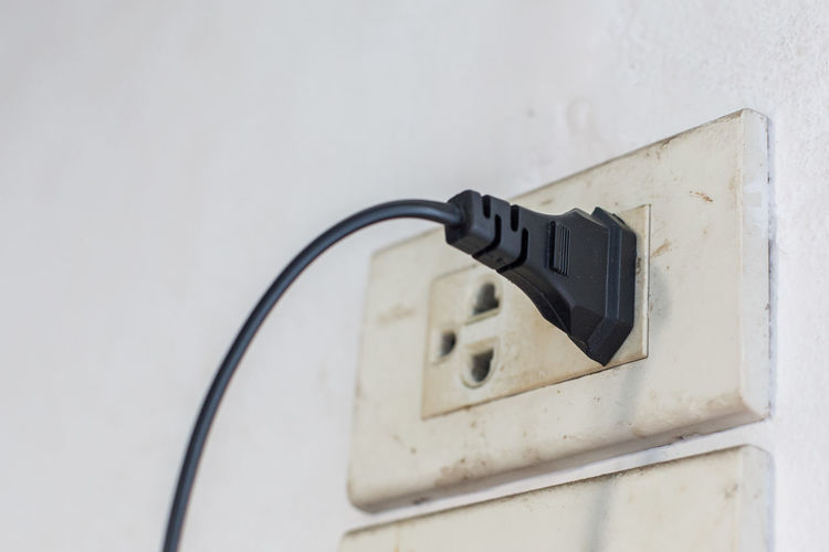 Close-up of electric plug in outlet