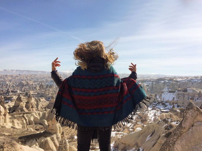 Rear view of a woman overlooking rocky landscape