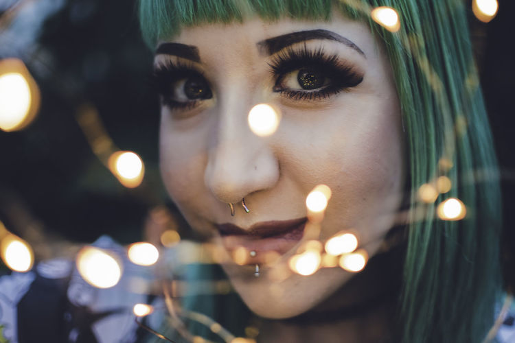 Close-up of illuminated young woman
