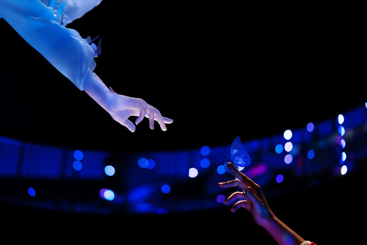 Hand touching hand showing connection between future and humanity