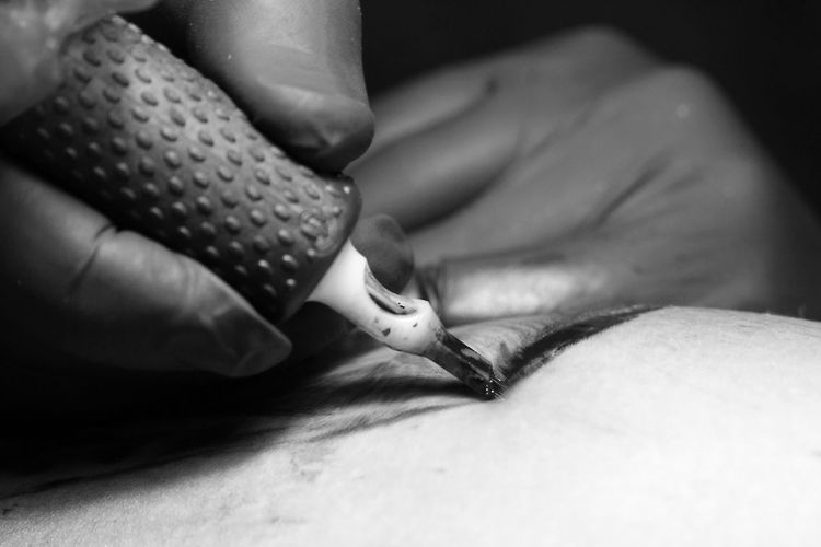 Close-up of person getting tattoo