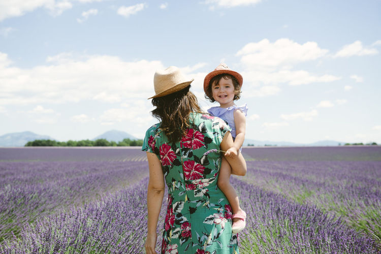 France, provence, valensole plateau, mother and daughter walking among lavender fields in the summer