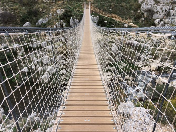 View of footbridge in mountains 