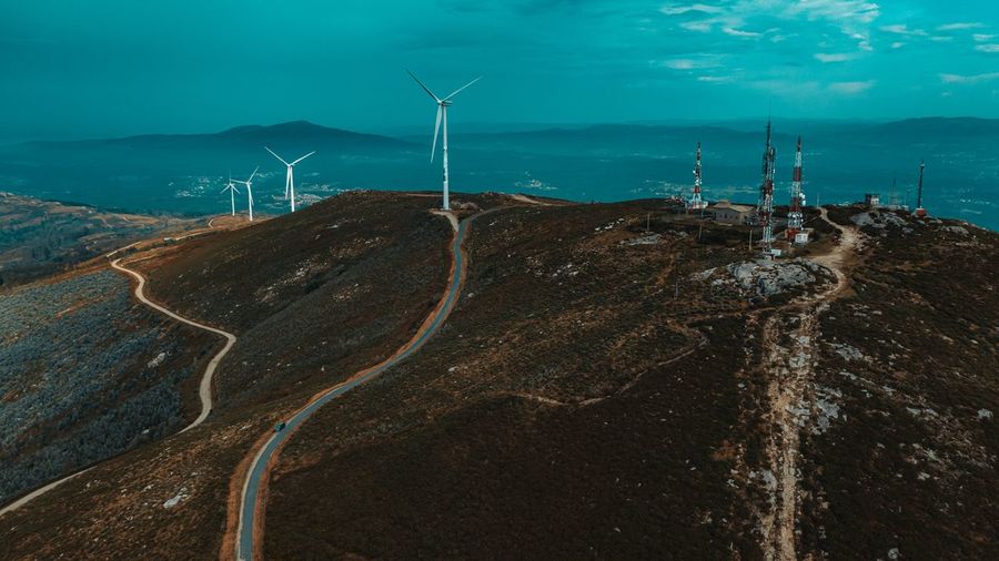 Panoramic view of wind turbines on land
