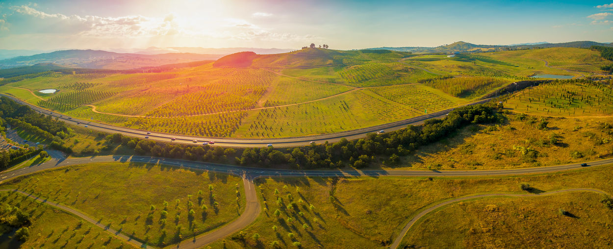 Aerial panorama of tuggeranong parkway and national arboretum at sunset in canberra, australia