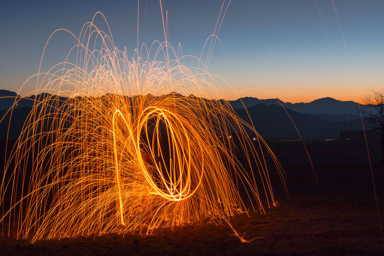 Light painting with fire against sky at night