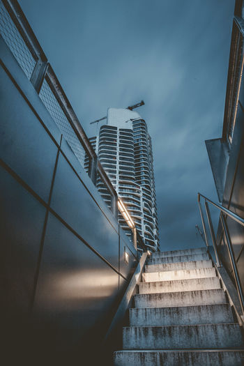 Low angle view of staircase by building against sky