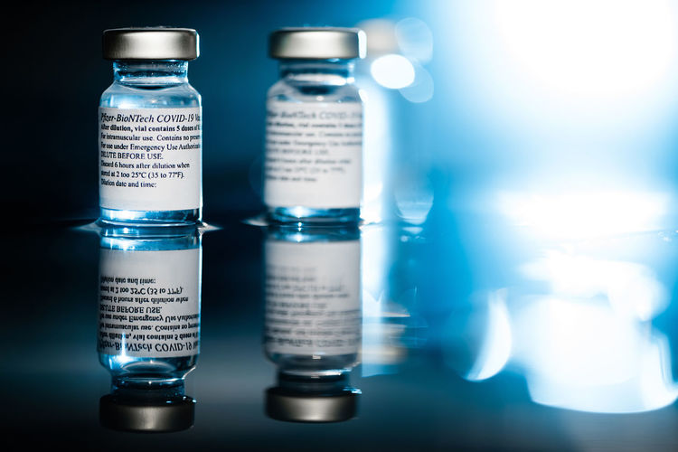 Close-up of glass bottle against blue background