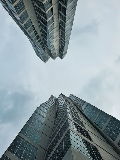 Directly below shot of office building exterior against sky