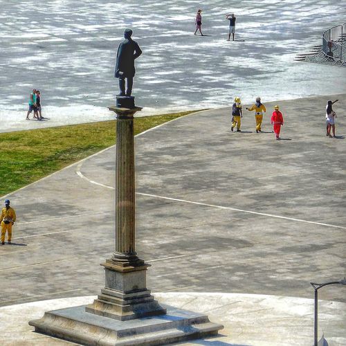 High angle view of people standing by sea