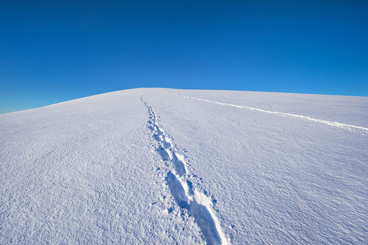 View of footprint on snow covered land