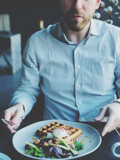 Midsection of man having breakfast