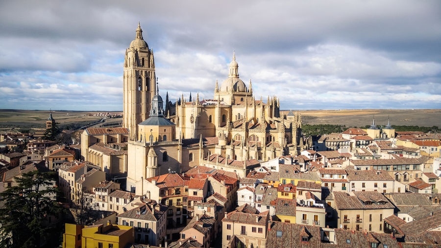 Cityscape of segovia town with the cathedral and cloudy blue sky