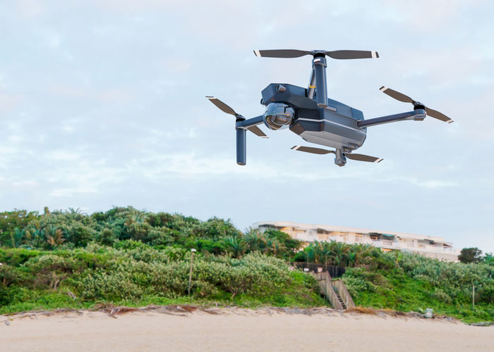 The high-tech drone flying in the sky. drone with professional camera takes pictures. copter 