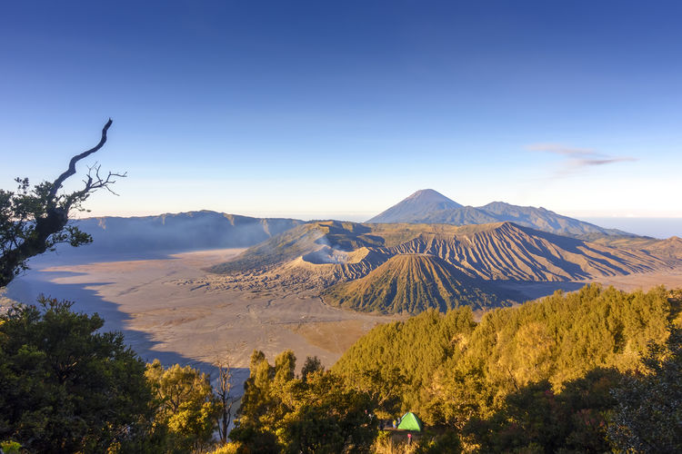 Scenic view of mountains against blue sky