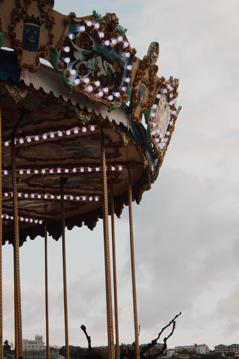 Low angle view of carousel against sky