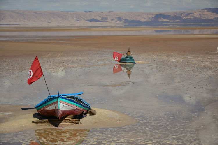 Boats moored on beach