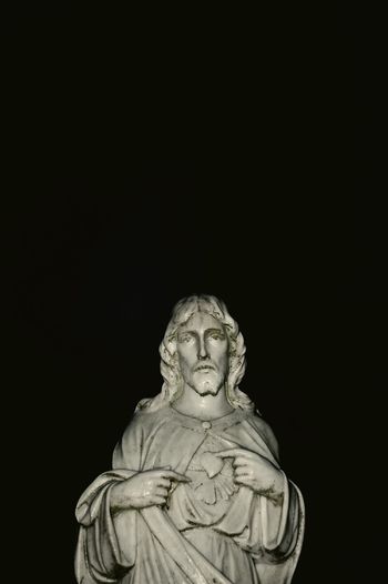 Close-up of statue against black background