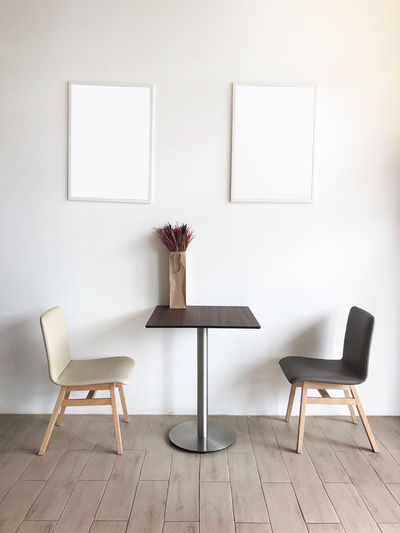Table and chairs on floor against wall at home