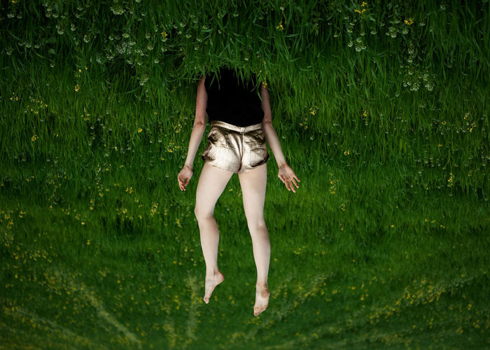 Upside down image of woman in grass