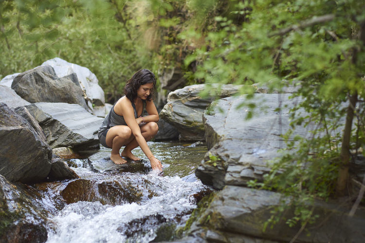 Young woman in a river. refreshes on a hot summer afternoon.