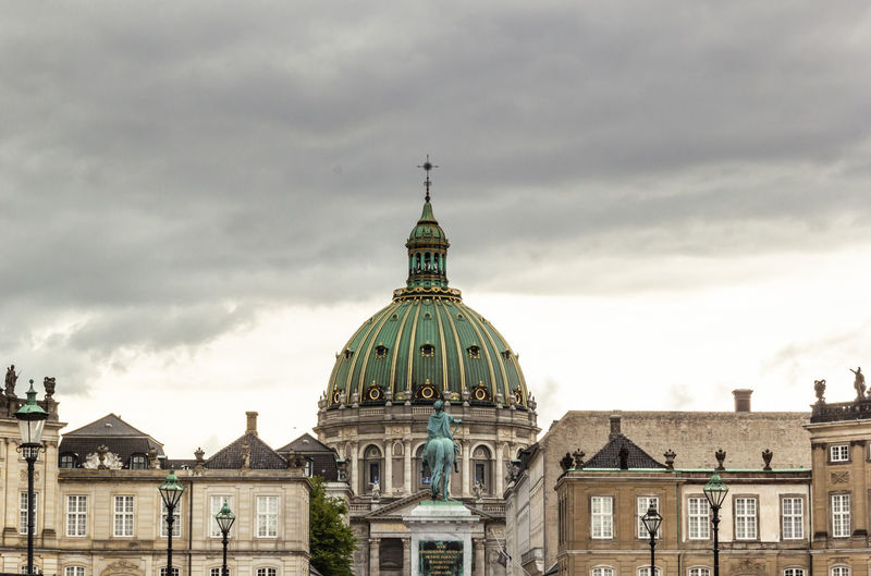 Equestrian statue of frederik v at amalienborg palace with background of frederik's church dome