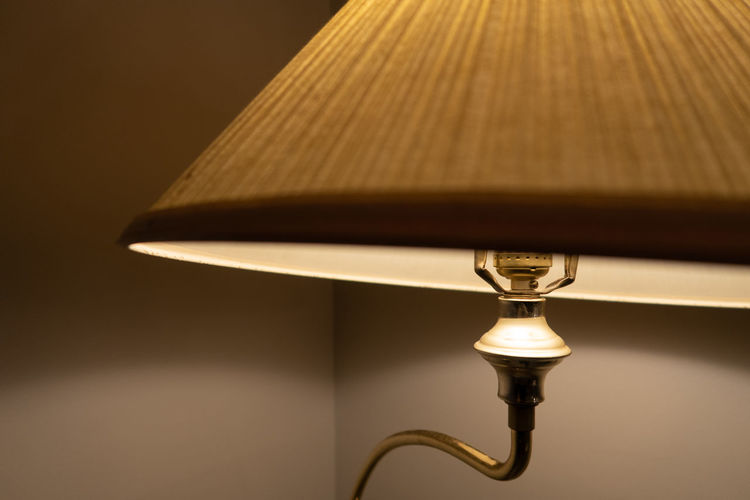 Close-up of electric lamp on table at home
